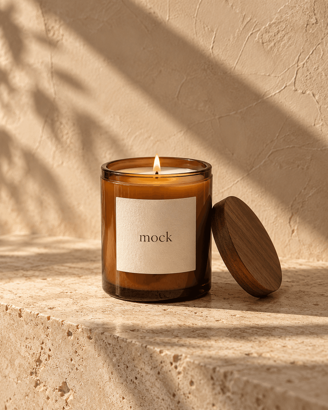 Amber glass mock candle with a cream sticker reading mock, beside a wooden lid in warm sunlight.